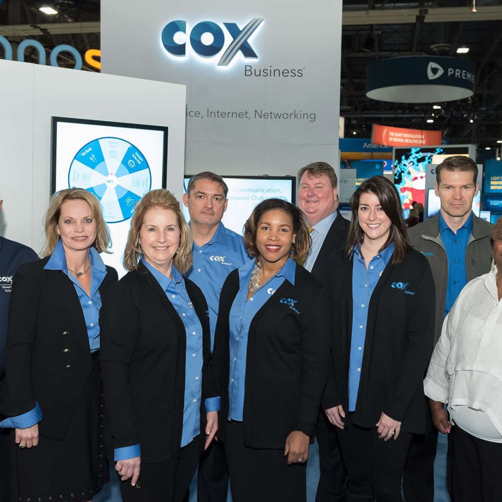 GROUP PHOTO IN EXHIBIT BOOTH